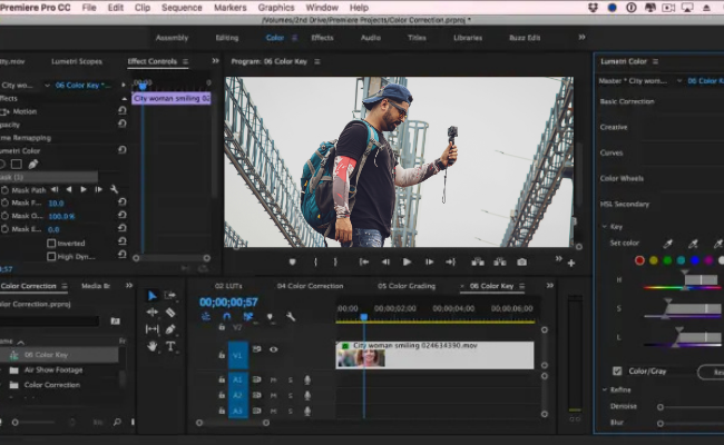 Video editing timeline in Adobe Premiere Pro featuring a travel vlogger holding a camera, showcasing cinematic color correction and storytelling-focused editing for YouTube vlogs and travel videos.