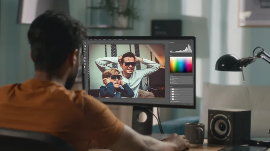 Man using professional editing software with color grading tools on a family video, illustrating affordable outsourced video color grading services as a cost-effective alternative to in-house editing teams.