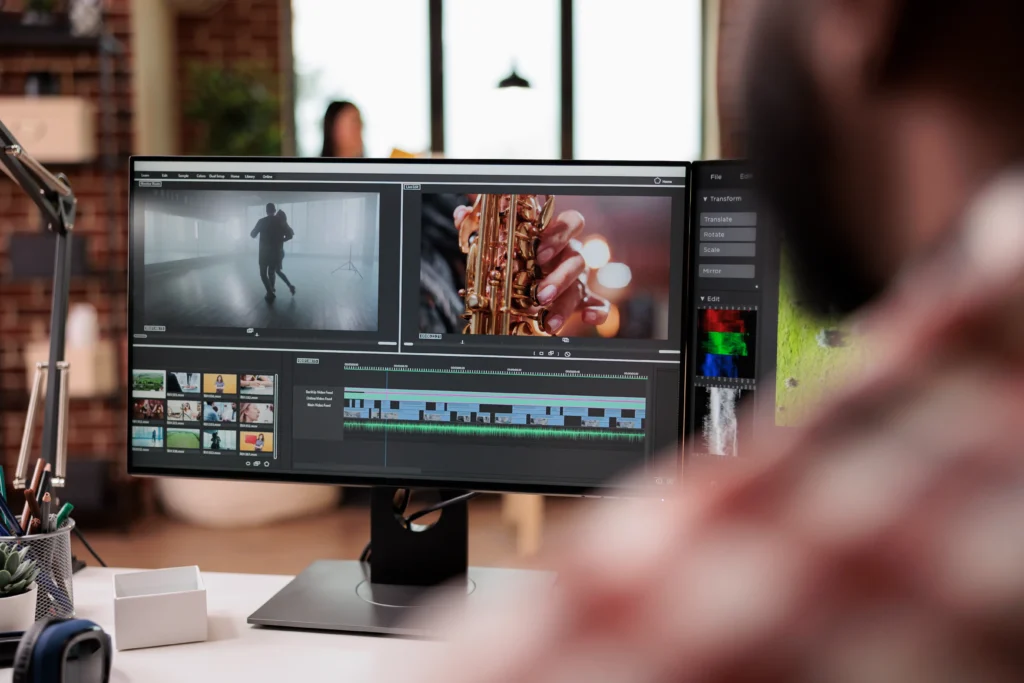 Video editor working on professional editing software at Eterna Edits, showcasing wedding and promotional video edits on a dual-screen setup for post-production services.