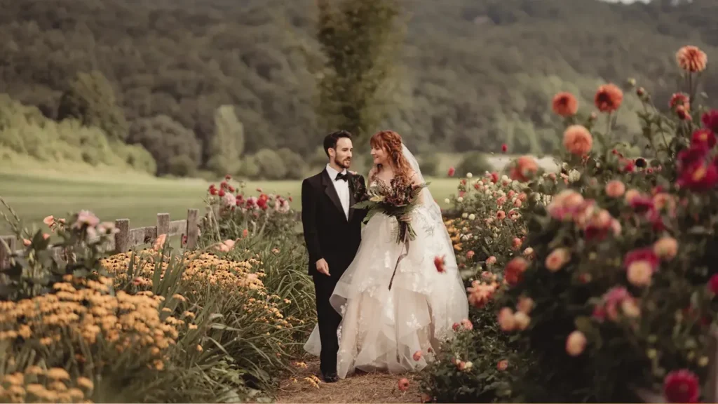 Bride and groom walking through a blooming flower garden, sharing a joyful moment captured for a cinematic and emotionally engaging wedding highlight video