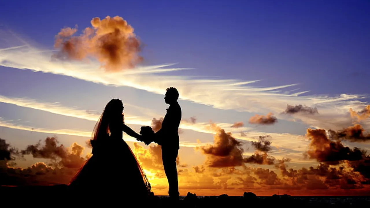 Bride and groom holding hands during a romantic sunset, perfect moment for a cinematic wedding highlight video showcasing emotional and memorable highlights for wedding