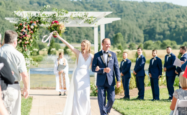Joyful bride and groom walking down the aisle at an outdoor wedding ceremony, celebrating with guests—perfect footage for branded wedding video edits ready for social media and client delivery.